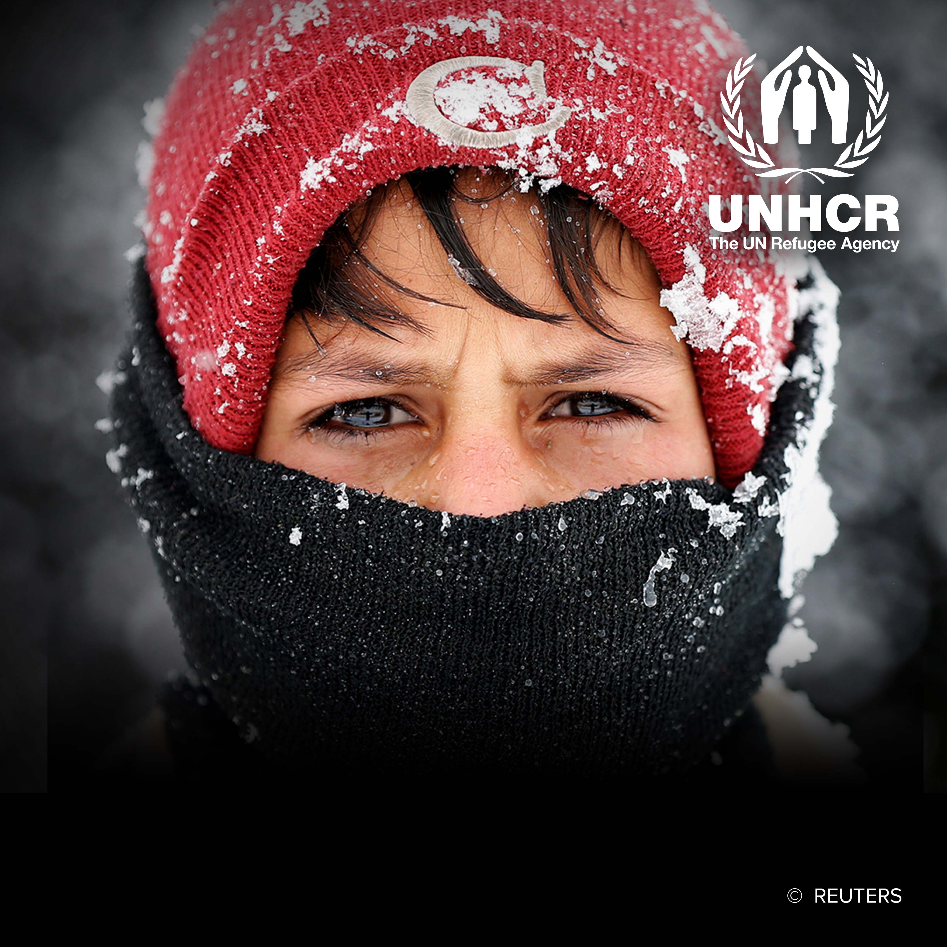 Displaced Afghan boy in winter attire