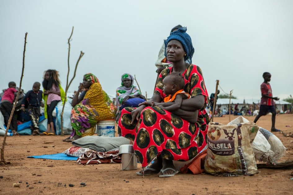 A South Sudanese returnee and mother-of-six, holds her baby at the UNHCR transit centre in Renk