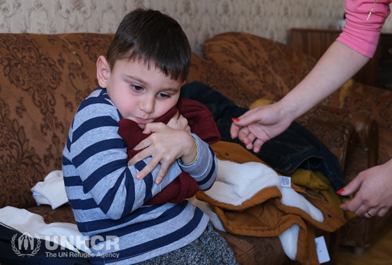 Armenia.  Children play in the snow wearing their donated warm coats.