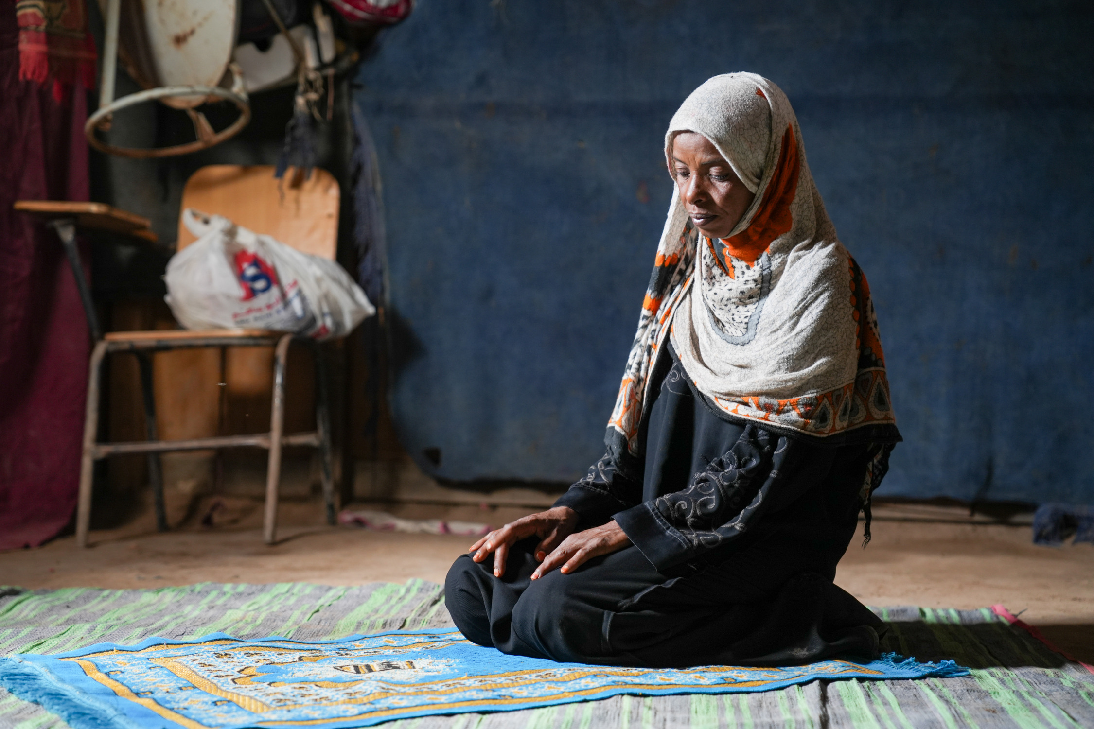A muslim woman sitting and praying