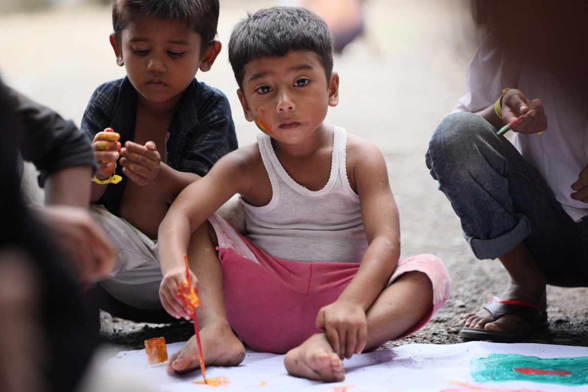 Rohingya children coloring a HOPE banner