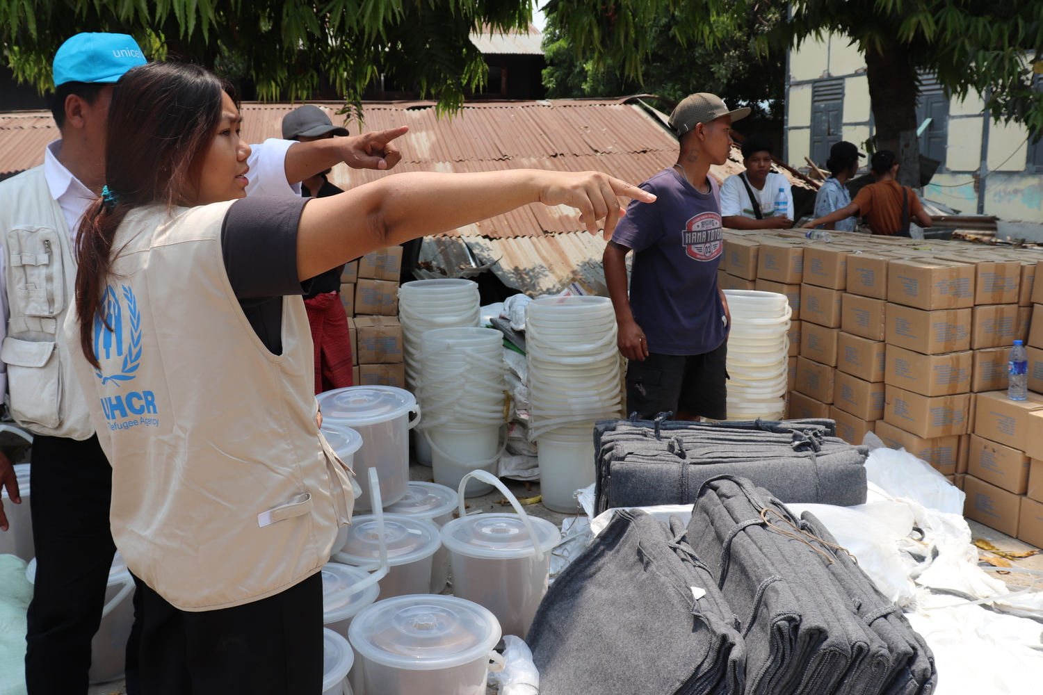 A UNHCR worker distributing aid in Myanmar