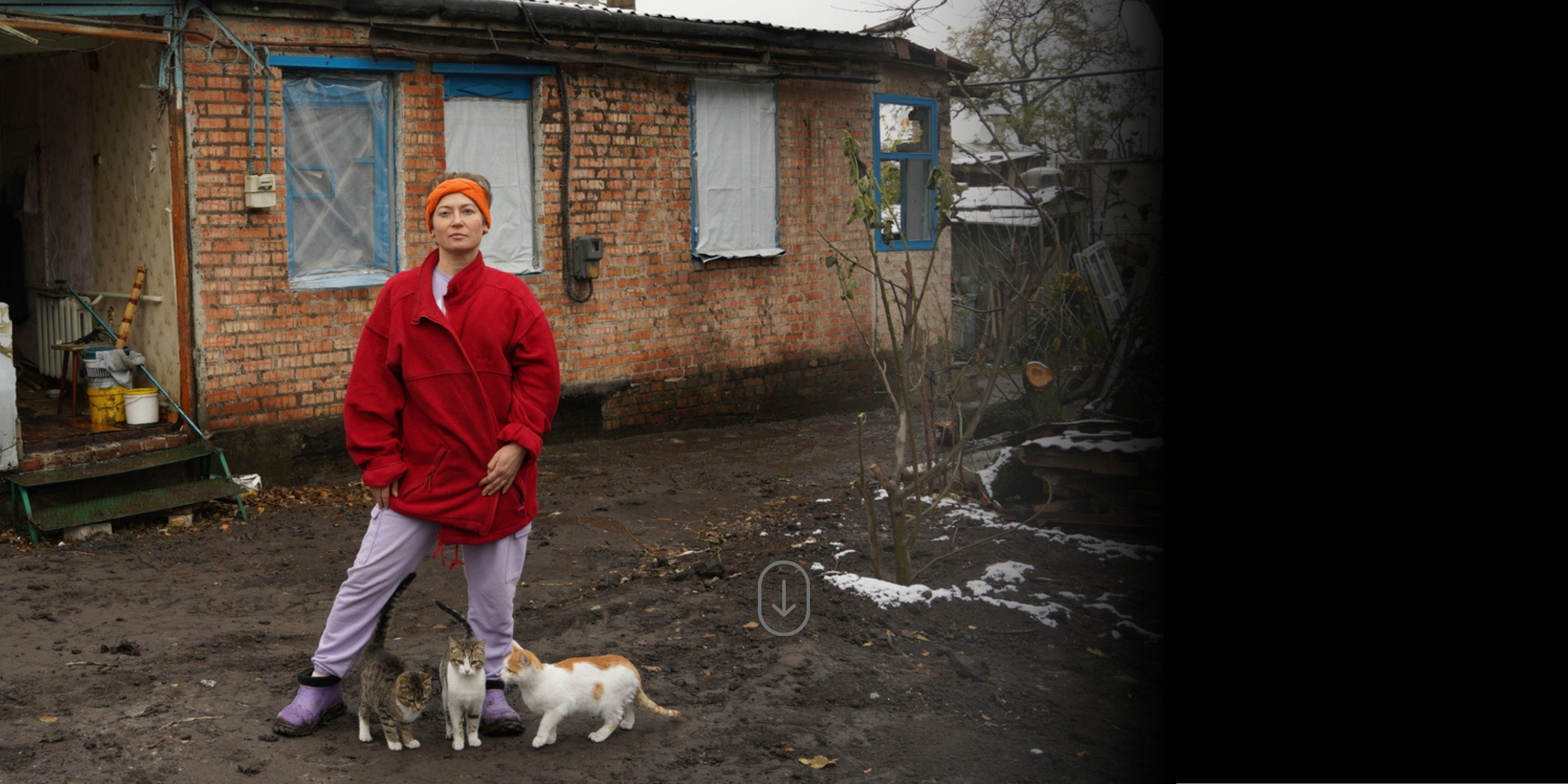 Nataliia, in front of what's left of her house in Ukraine