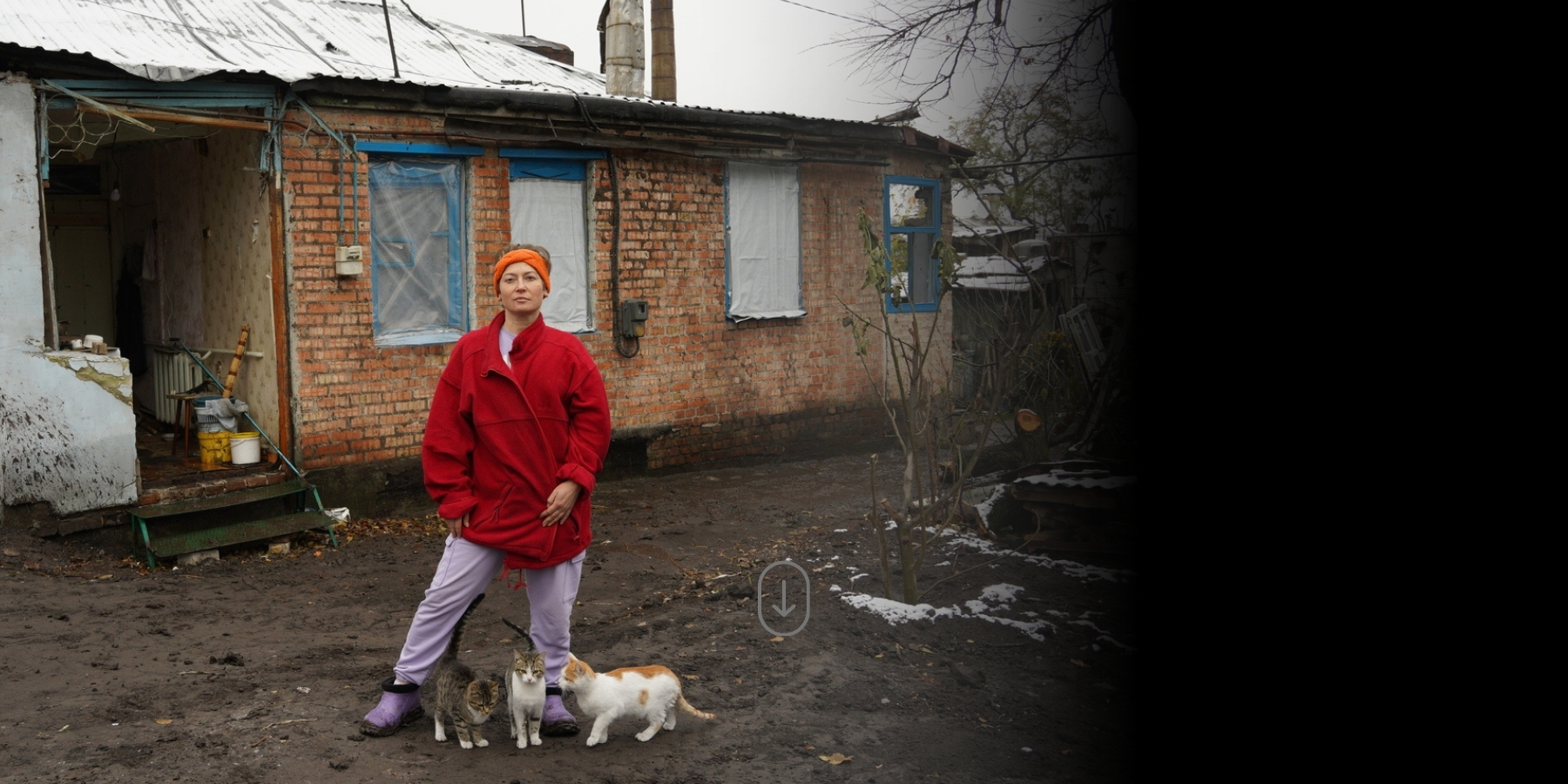 Nadiia, in front of what's left of her house in Ukraine