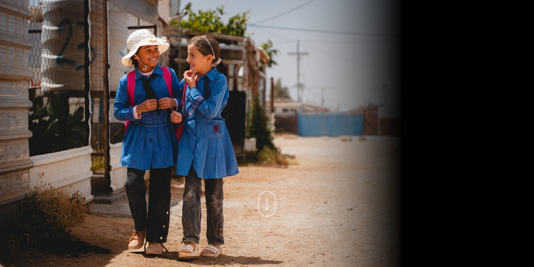 Salam (8) and Ghazal (9) returning from school in Zaatari Refugee camp, Jordan