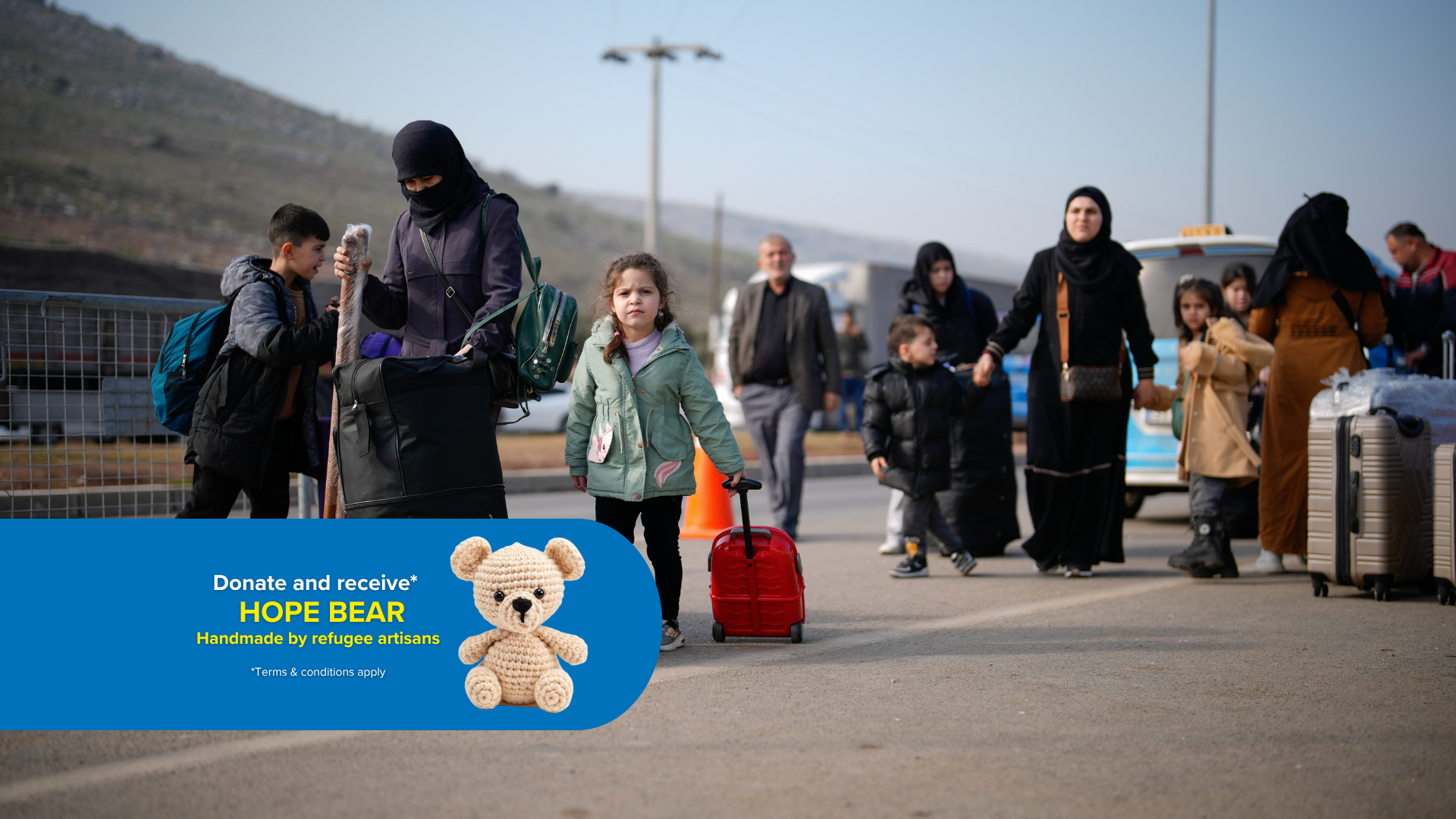 Refugees are travelling along a tarmac road