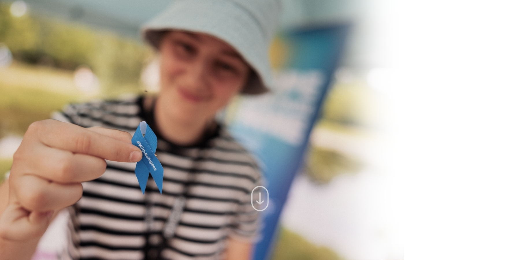 Boy holding solidarity ribbon in support of refugees