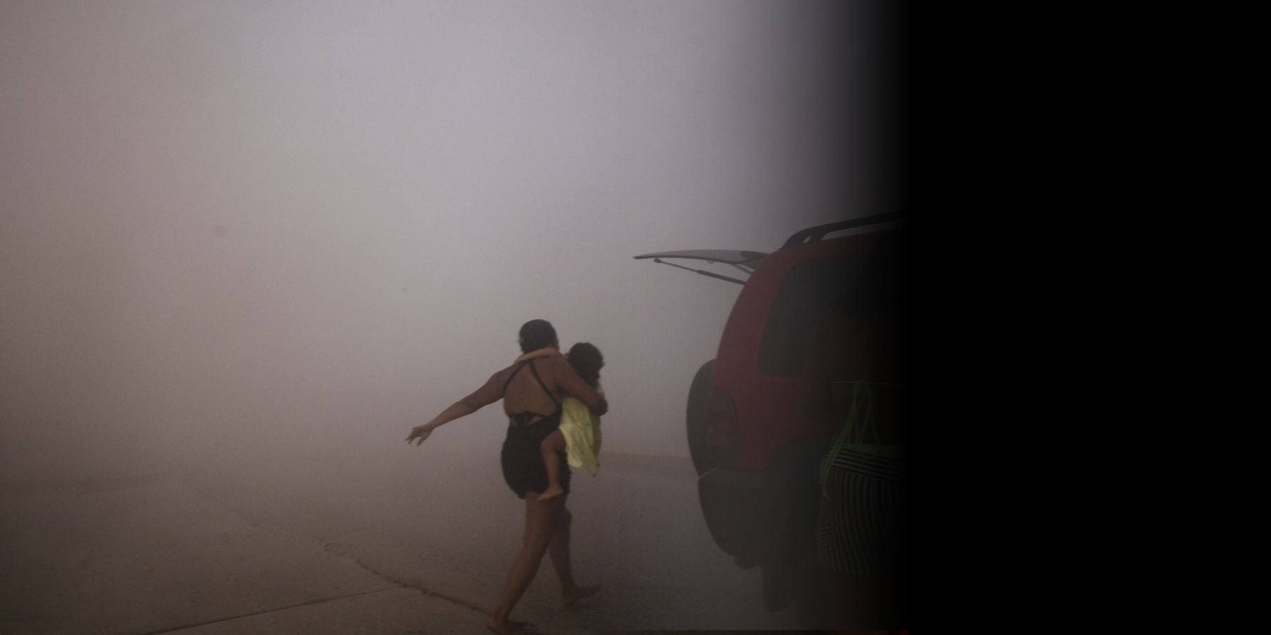 Mother and child running away from earthquake in Venezuela