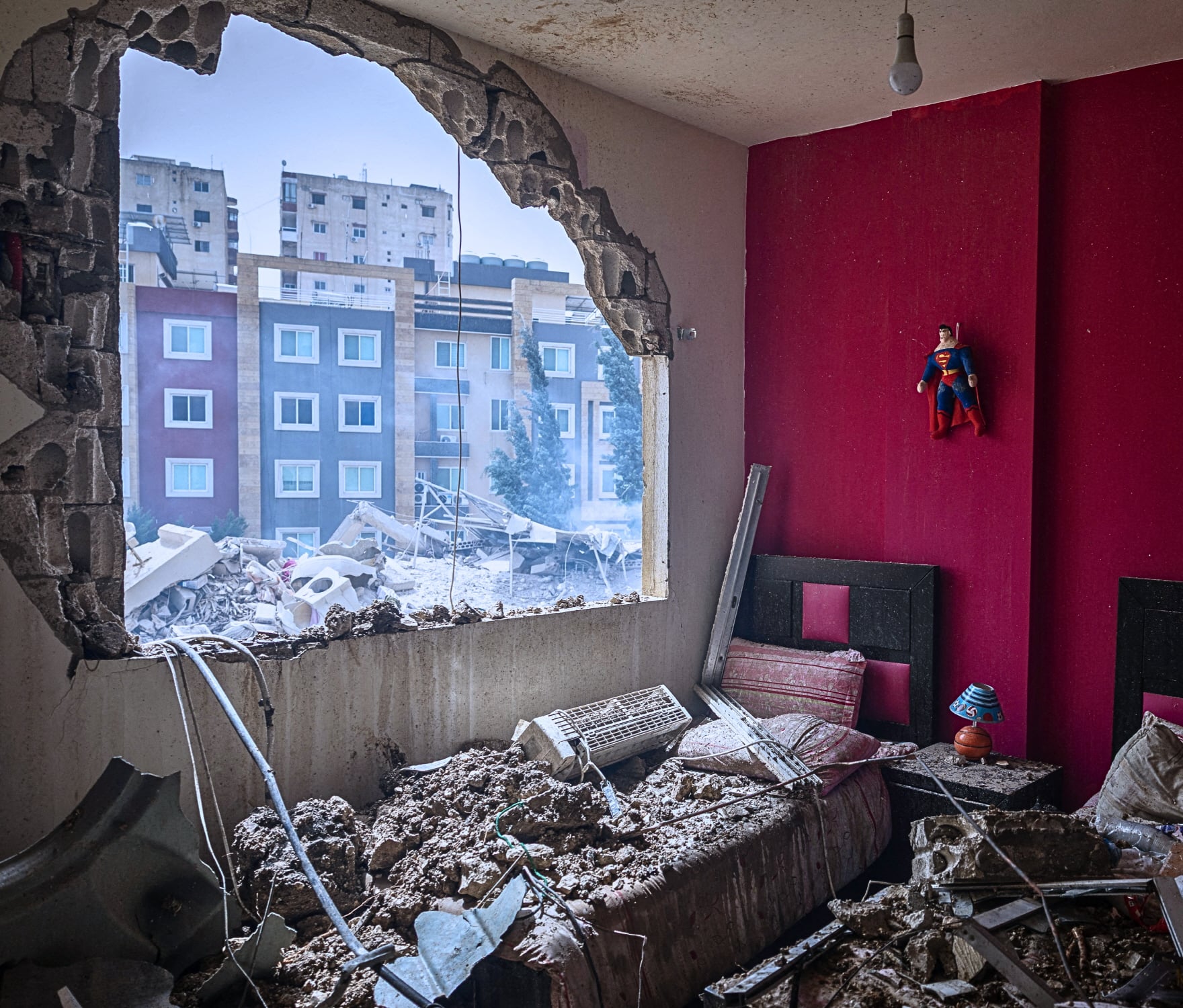 A Superman figure hangs on a wall in a room at a house damaged in an Israeli airstrike In Tyre, Lebanon.