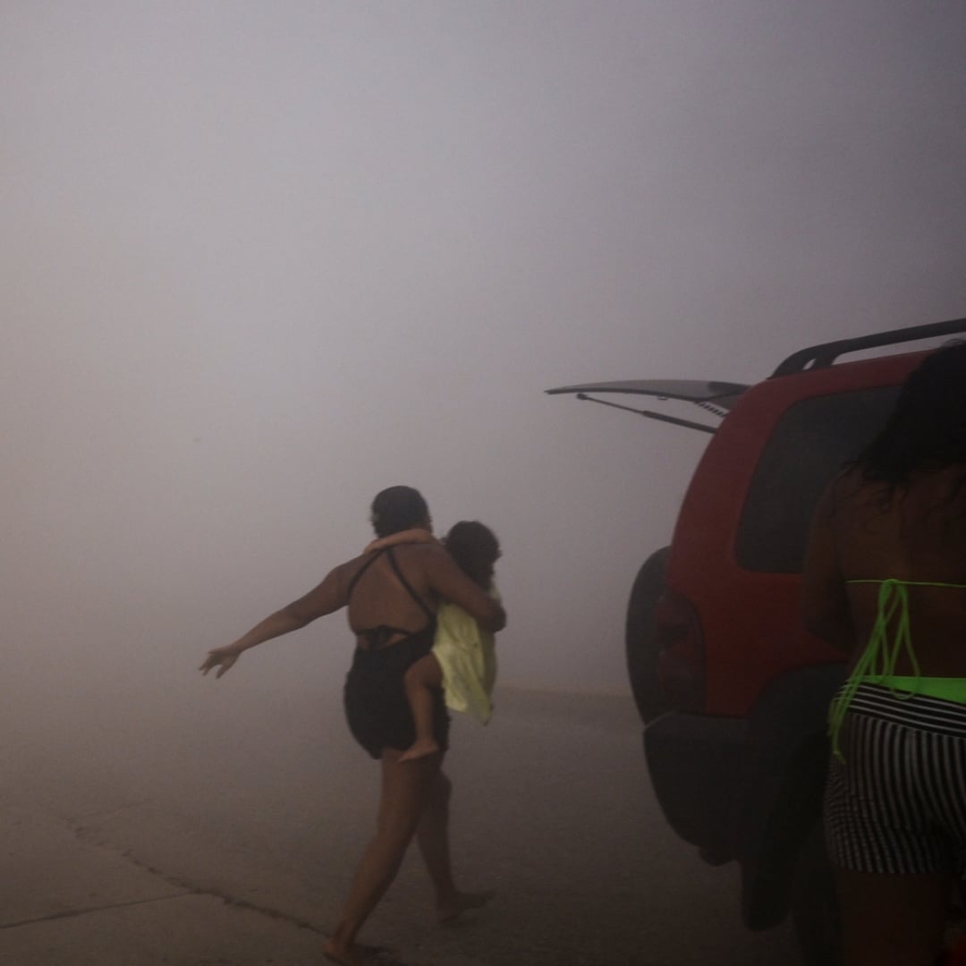 Mother and child running away from Earthquake in Venezuela