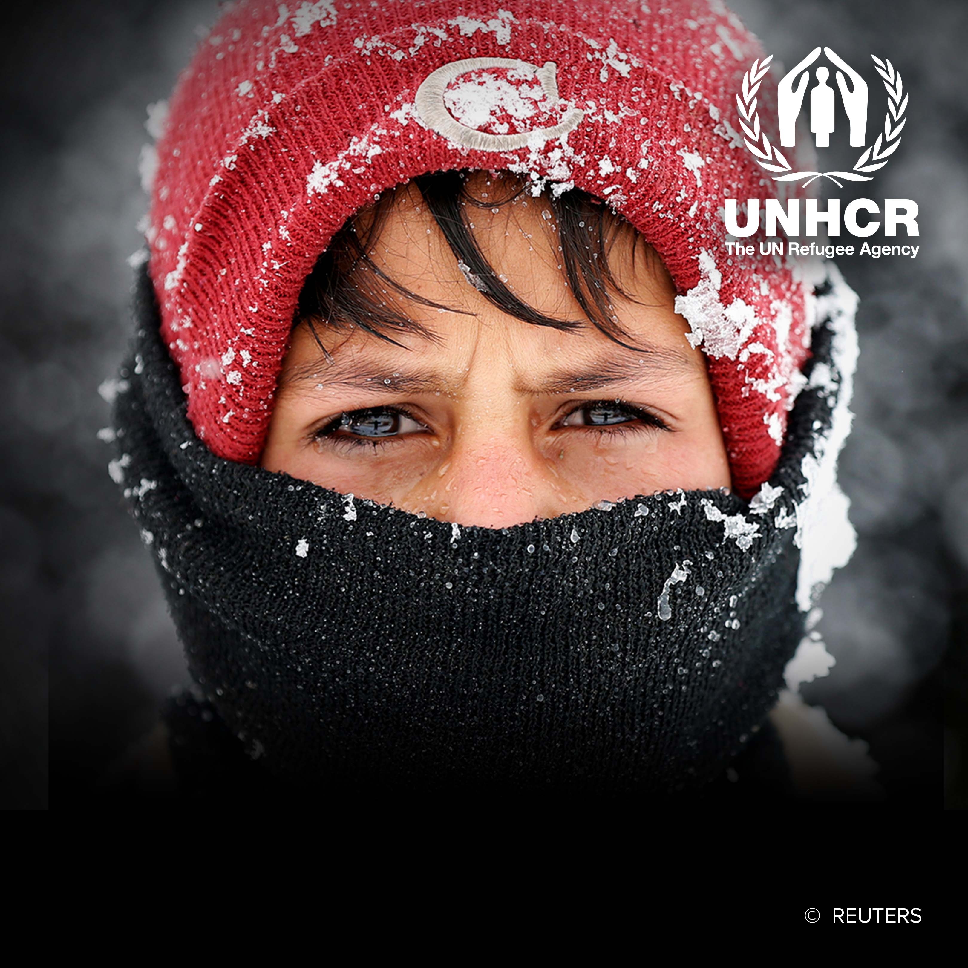 Displaced Afghan boy in winter attire 
