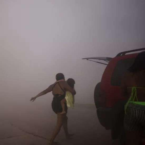 Mother and child running away from Earthquake in Venezuela