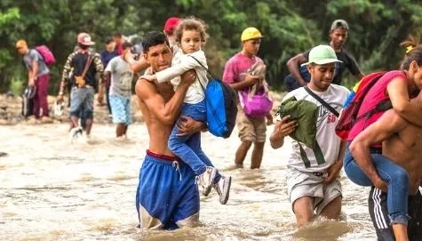 Refugee family crossing the river. 