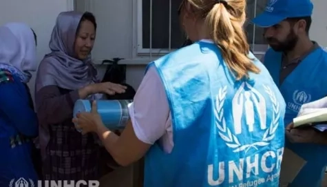 UNHCR staff delivering aids.